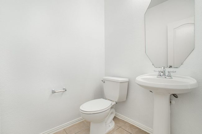 Bathroom featuring baseboards, toilet, and tile patterned flooring | Image 15