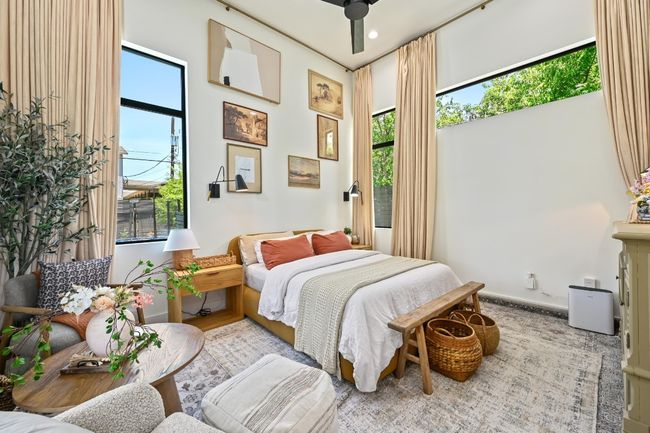 Primary bedroom on main level with high ceilings and access to patio. | Image 12