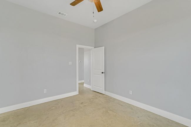 Spare room featuring concrete flooring, ceiling fan, and baseboards | Image 16