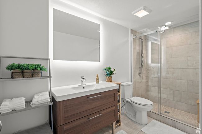 Bathroom featuring vanity, a stall shower, and tile patterned flooring | Image 43