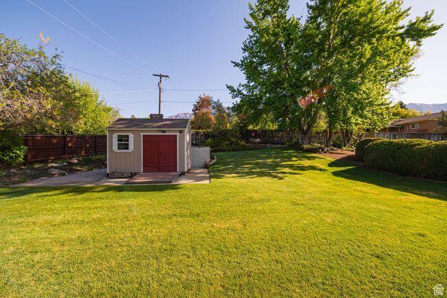 View of yard featuring an outdoor structure, a fenced backyard, and a shed | Image 8
