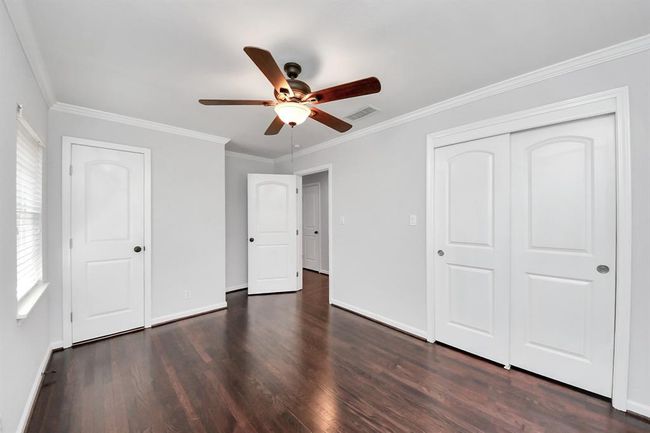 Primary BR shows door to bathroom & sliding closet doors | Image 13