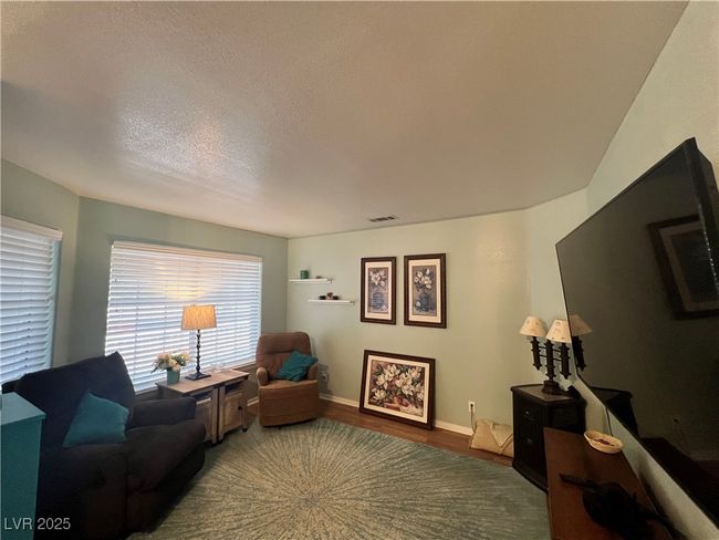 Living room with wood finished floors and a textured ceiling | Image 14
