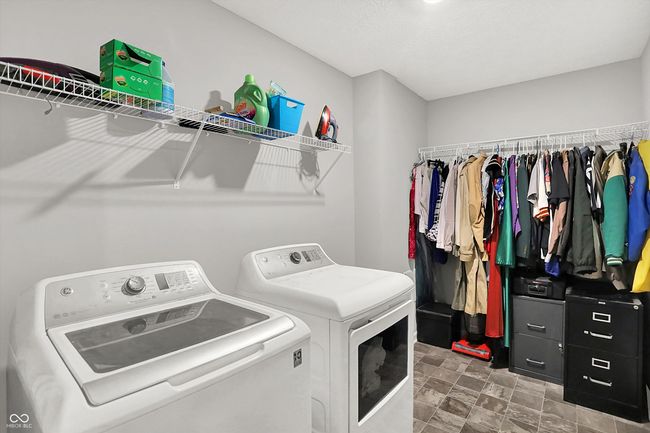 Upstairs laundry room - with shelving and a rack for hang drying clothes or extra storage | Image 29