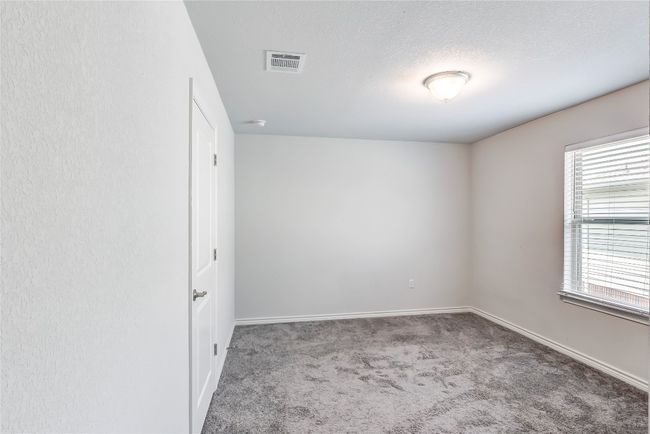 Unfurnished room with carpet floors, baseboards, a textured ceiling, and a smoke detector | Image 28