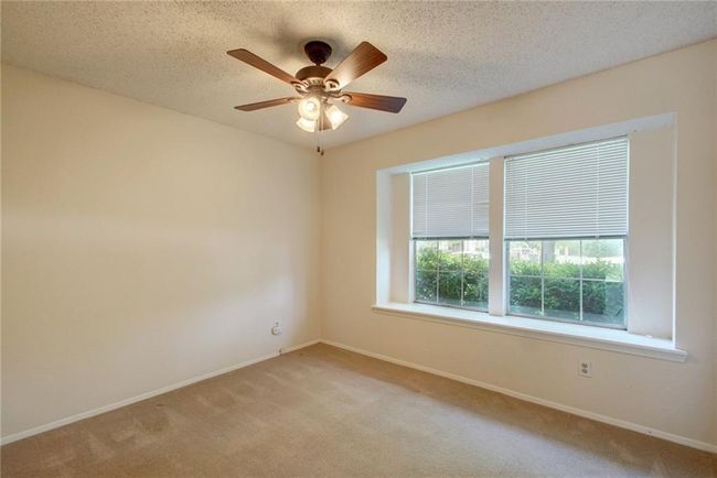 Unfurnished room featuring baseboards, a ceiling fan, and light colored carpet | Image 20