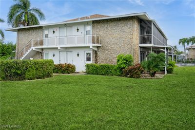 Rear view of property with a balcony and a yard | Image 1