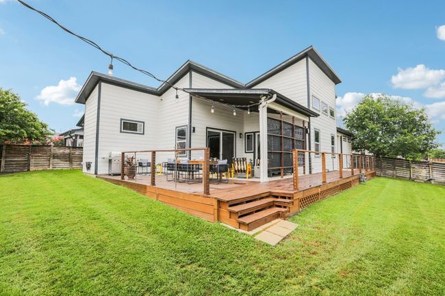 Back of house with a fenced backyard and a deck | Image 37