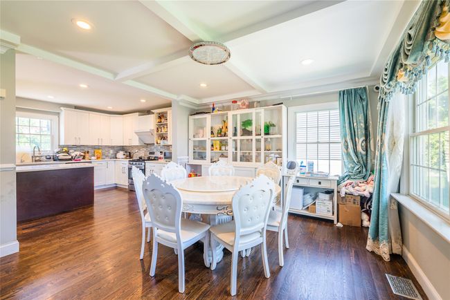 Dining area with dark wood-type flooring, beamed ceiling, recessed lighting, and baseboards | Image 15