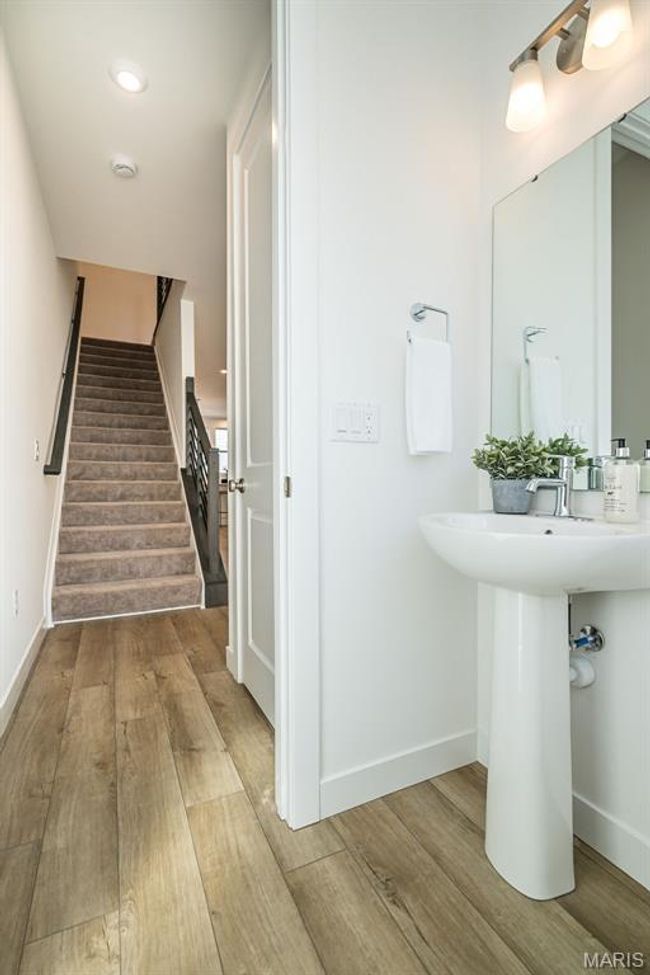 Bathroom with wood finished floors and recessed lighting | Image 19
