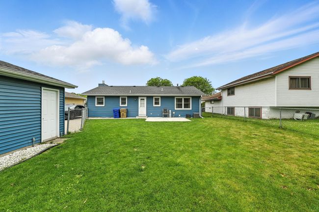 fully fenced backyard view | Image 17