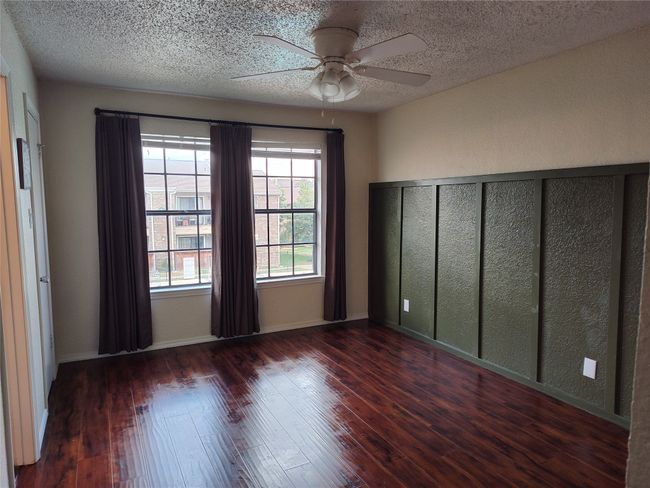 Unfurnished room featuring a ceiling fan, and dark hardwood / wood-style floors | Image 11