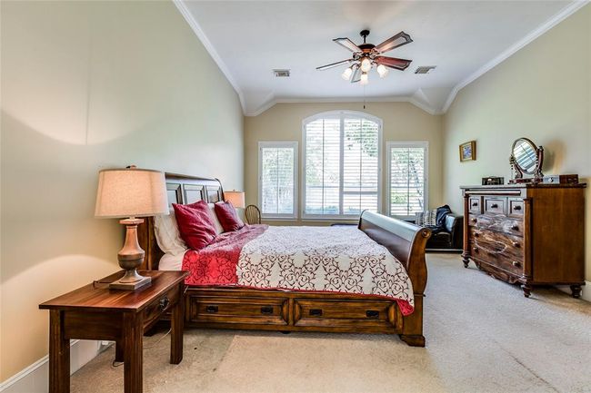 Large Master Suite, large windows with views of the pool, plantation shutters, high ceilings, ceiling fan, carpet | Image 23