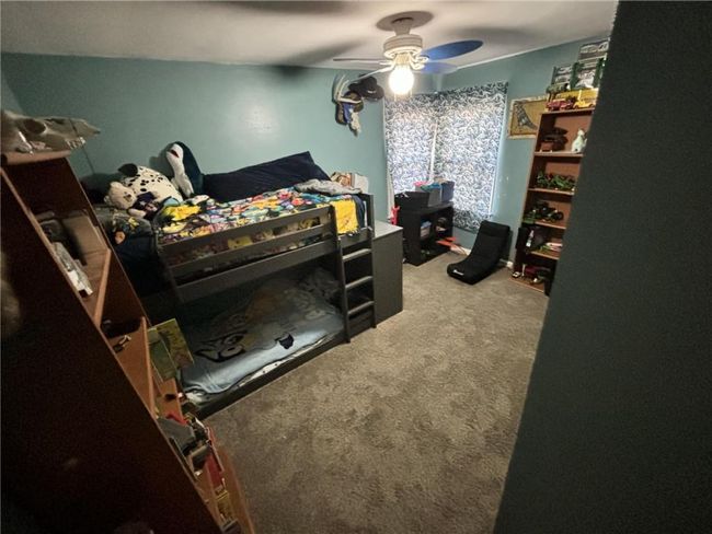 Carpeted bedroom featuring a ceiling fan | Image 23