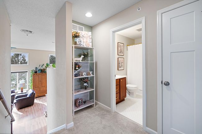 Upstairs landing with linen closet and extra nook for a desk or decor. | Image 23