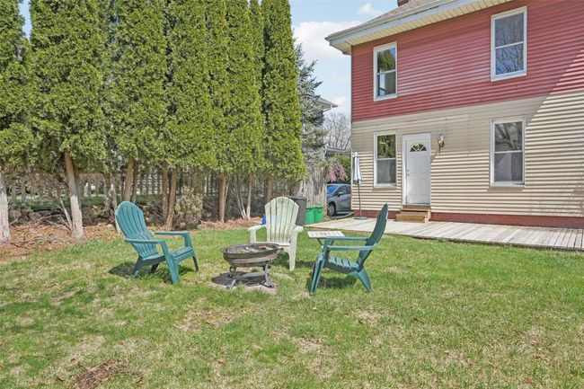 View of yard featuring entry steps and a fire pit | Image 38