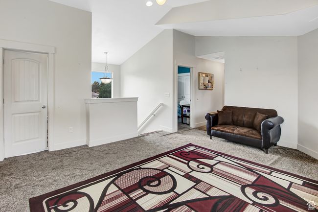 Living room with vaulted ceiling and carpet flooring | Image 22