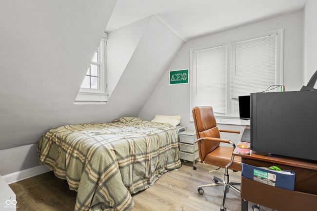 bedroom with vaulted ceiling and wood finished floors | Image 6
