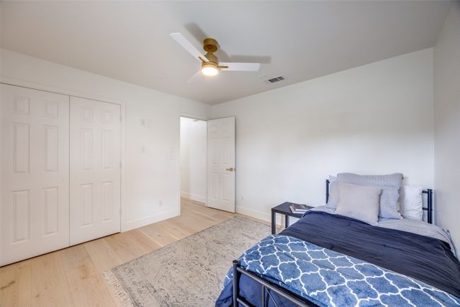 Bedroom with wood finished floors, a ceiling fan, and a closet | Image 31
