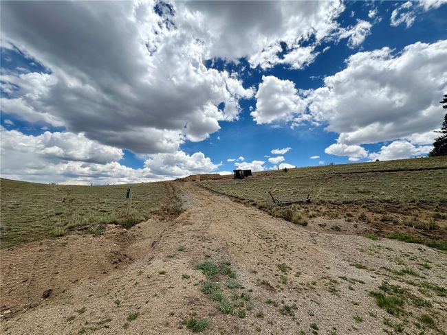 View of dirt / gravel road with a rural view | Image 18