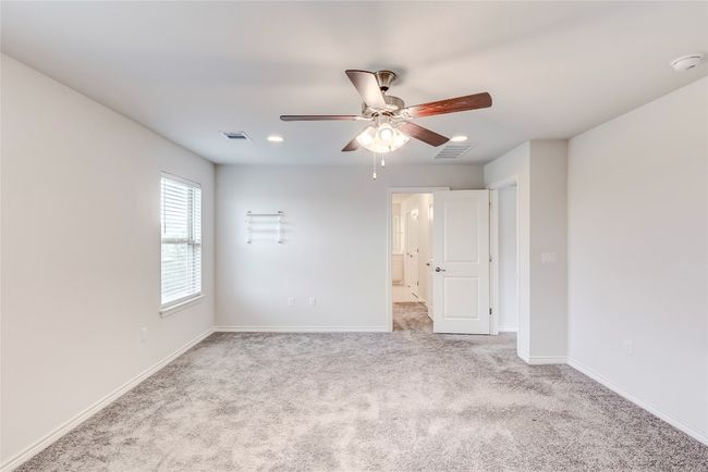 Carpeted empty room with a ceiling fan, baseboards, a smoke detector, and recessed lighting | Image 22