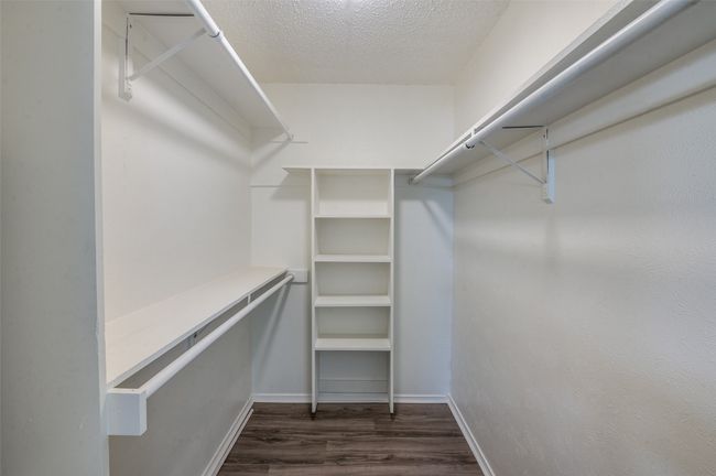 Spacious closet featuring dark wood-type flooring | Image 16