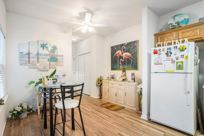 Dining space featuring light wood-style flooring and ceiling fan | Image 8