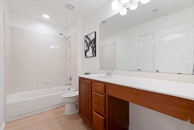 A second full bathroom is conveniently located near the secondary bedrooms and is easily accessible for guests. | Image 16