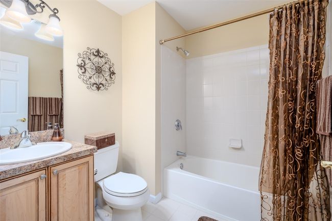 Full bath featuring vanity, tile patterned flooring, and shower / tub combo | Image 17