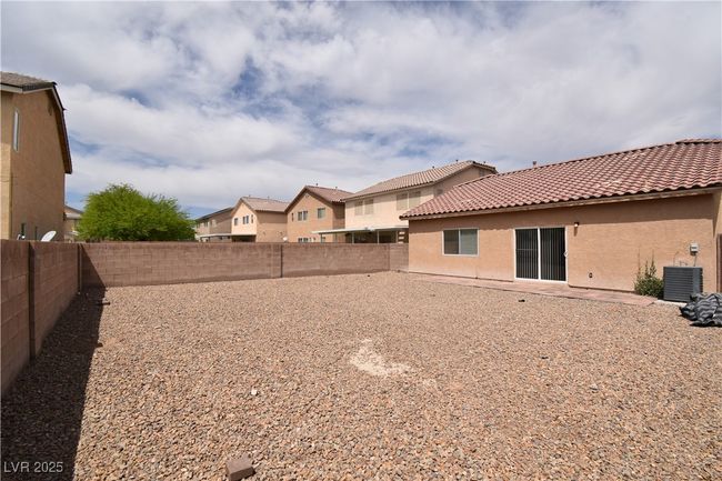 View of yard featuring a fenced backyard and central AC | Image 25