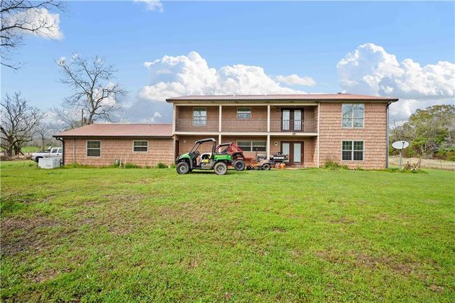 Rear view of property with a balcony, a lawn, and french doors | Image 28