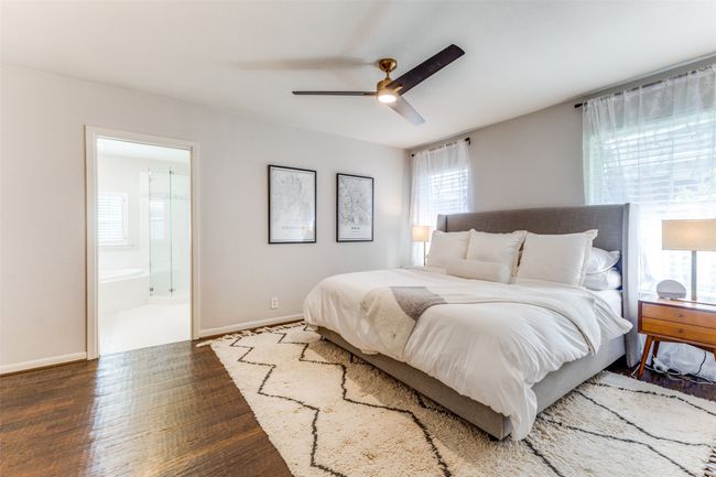 Large Primary Bedroom featuring hand-scraped wood floors, ensuite bathroom, and ceiling fan | Image 16