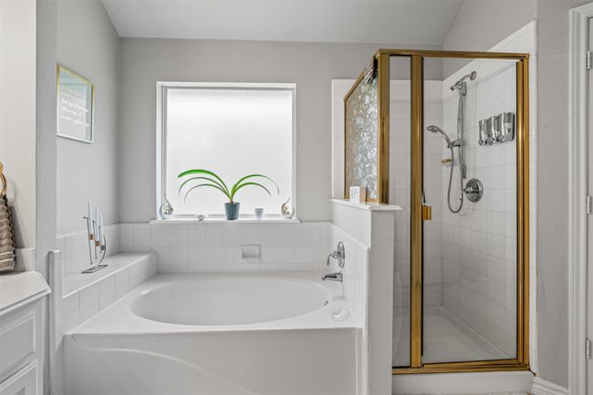 Full bath featuring a bath and a stall shower | Image 15