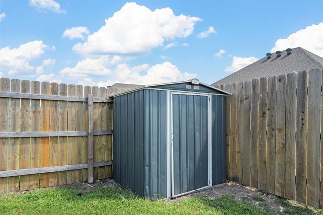 View of shed featuring a fenced backyard | Image 34