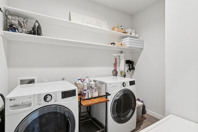 Laundry area with washing machine and clothes dryer and baseboards | Image 22