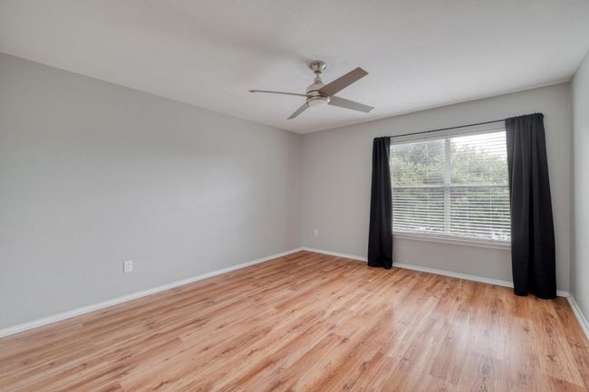 Empty room featuring light wood finished floors and ceiling fan | Image 28