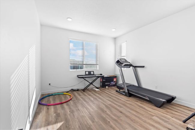 Exercise room featuring wood finished floors and baseboards | Image 14
