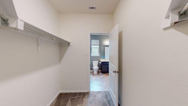 Walk in closet featuring carpet floors and visible vents | Image 10