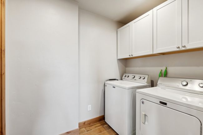 Clothes washing area with cabinets and washing machine and clothes dryer | Image 48