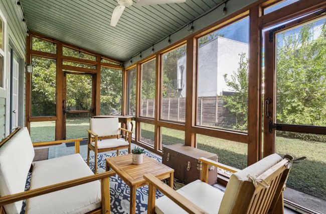 Sunroom / solarium with a ceiling fan, plenty of natural light, an outdoor living space, and lofted ceiling | Image 23