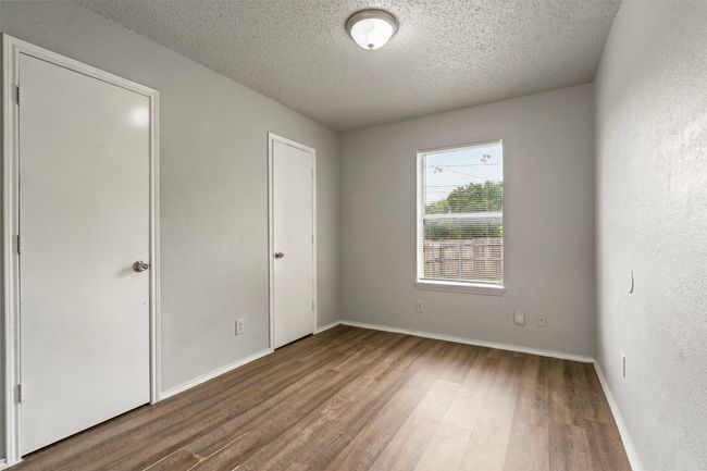 Unfurnished bedroom featuring wood finished floors, a textured ceiling, and baseboards | Image 19