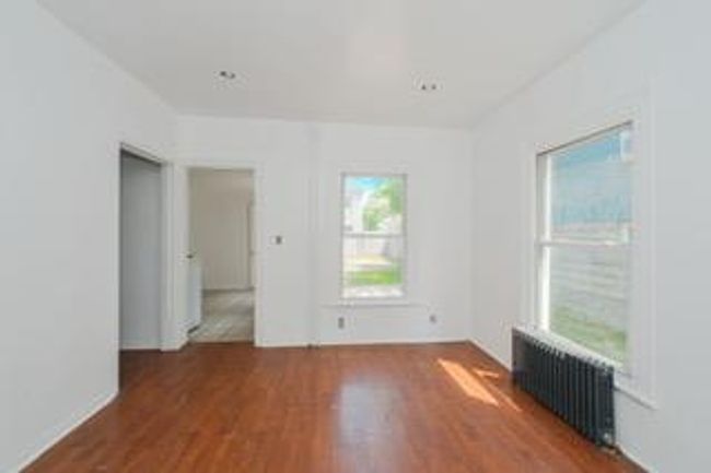 Unfurnished room with radiator heating unit and wood finished floors | Image 22