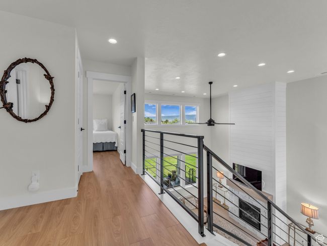 Hall featuring light wood-style flooring, recessed lighting, baseboards, and an upstairs landing | Image 41
