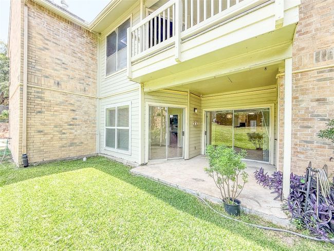 Entrance to property featuring a yard and a patio | Image 12