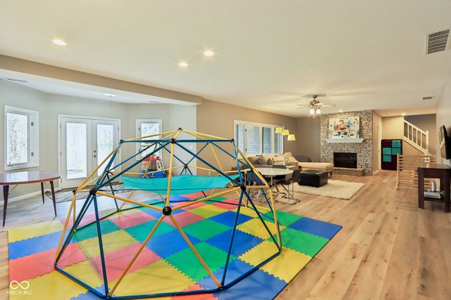 playroom featuring recessed lighting, visible vents, a stone fireplace, ceiling fan, and wood finished floors | Image 43