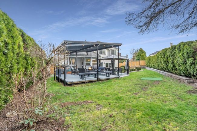 Back of house featuring a gazebo, a deck, a lawn, and fence private yard | Image 34