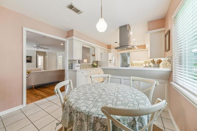 This spacious kitchen, open to the family room, features a breakfast bar for extra seating, perfect for cooking and entertaining. | Image 11