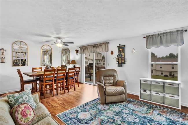 The open concept living/dining area provides ample space for large gatherings with access through the sliding door to the gated back deck. | Image 6