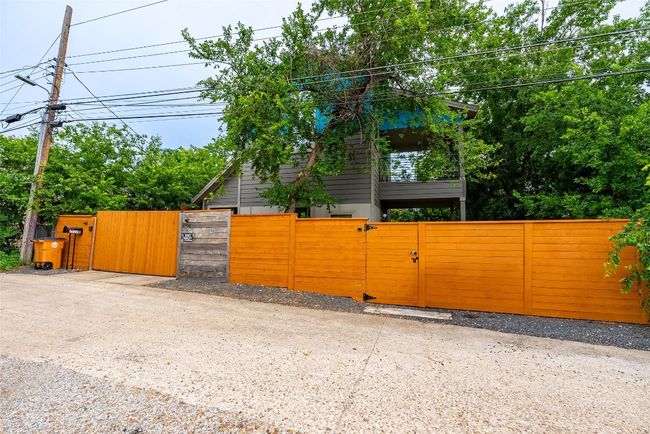 View of property exterior with a gate and a fenced front yard | Image 14