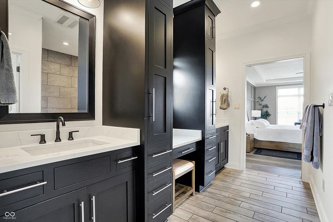 full bath featuring ensuite bathroom, visible vents, crown molding, vanity, and wood finish floors | Image 27